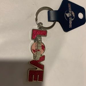 Key Chain from Universal Studios. Pink glitter very pretty. Back side has ❤️on I